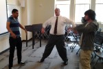 Students including Ethan Telila (L) help me demonstrate how a tension-relieving physical and vocal warmup frees our bodies for expressive performance. Photo: Josh Ortman.