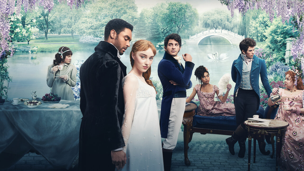 The cast of Bridgerton pose in full costume against a background of a lavish, carefully maintained garden.